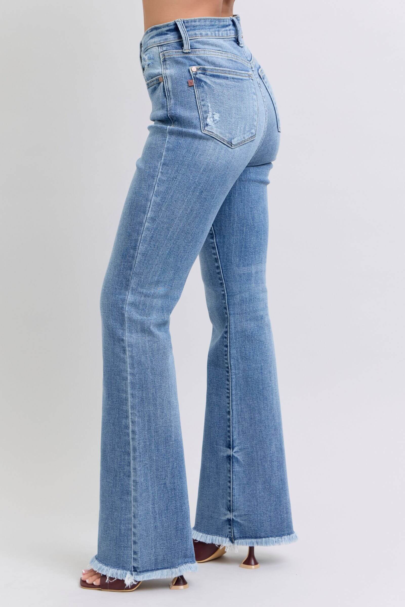 Stylish Judy Blue high rise bootcut jeans with raw hem, flattering fit, and vintage-inspired flare, perfect for a trendy look.