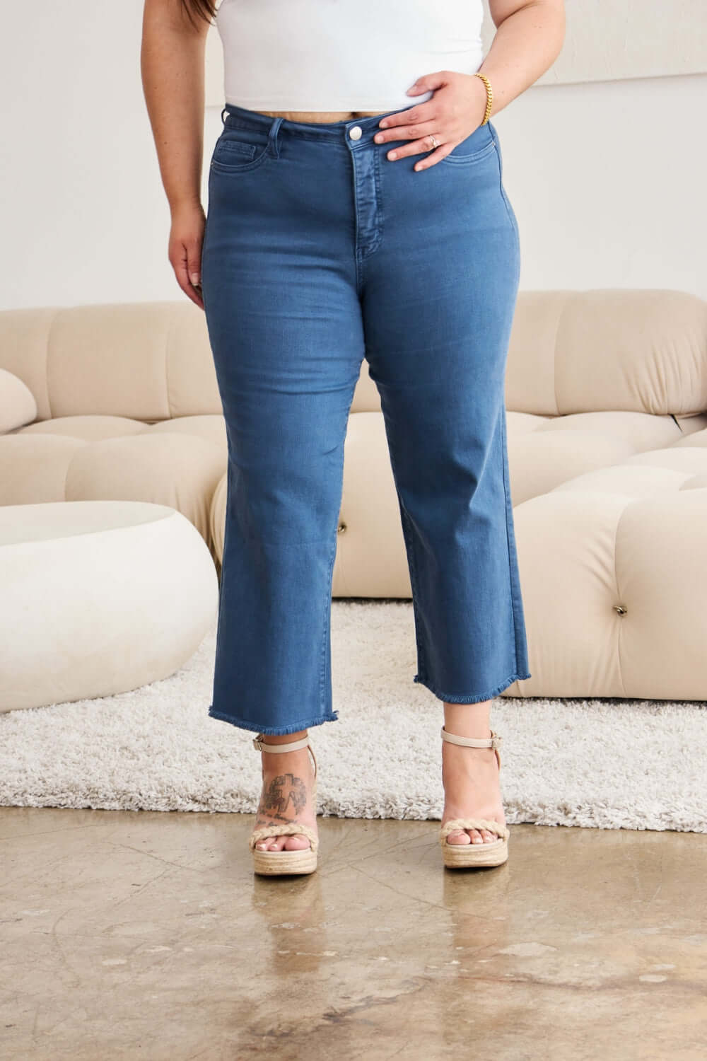 Woman wearing Crop Chloe full size tummy control high waist raw hem jeans, showcasing relaxed fit and trendy style from RFM Jeans