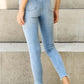 Woman in Button Fly Raw Hem Judy Blue Jeans, full size, showing back pockets and casual, stylish design with moderate stretch.