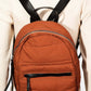 Adjusted back view of a stylish orange nylon backpack with black straps, perfect for everyday use or travel.