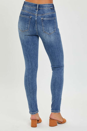 Woman wearing mid rise ankle skinny jeans with a comfortable fit and trendy ankle length, highlighting the sleek Risen Jeans design.