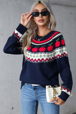 Woman wearing an angel wings sweater with apple graphic, round neck, and long sleeves, styled with jeans and sunglasses.