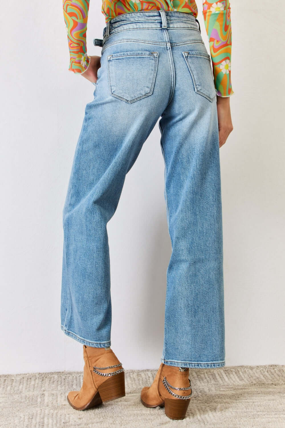 High Waist Wide Leg Jeans with back pockets, cowboy boots and a colorful top, showcasing a classic wide-leg design and regular hem