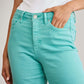 Woman wearing high waist raw hem jeans in turquoise for tummy control by RFM Jeans