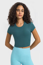 Millennia cropped sports t-shirt in teal, featuring a round neck and short sleeves, perfect for yoga and workouts.