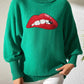 Bella Road Lip Turtleneck Sweater in green featuring bold red lip design, perfect for quirky and stylish fashion statements.