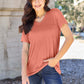 Woman wearing Basic Bae Bamboo V-Neck Short Sleeve T-Shirt, posing outdoors in a casual outfit