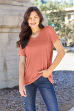 Woman wearing Basic Bae Bamboo V-Neck Short Sleeve T-Shirt, posing outdoors in a casual outfit