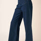 High-waisted wide leg jeans made from soft denim knit, featuring patch pockets, zip fly closure, paired with white sandals.