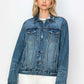 Model showcasing a RISEN full-size distressed button-up denim jacket with a classic look and modern edge.