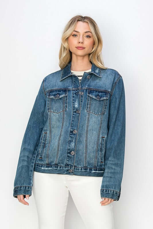 Model showcasing a RISEN full-size distressed button-up denim jacket with a classic look and modern edge.