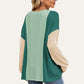 Stylish woman wearing Double Take Texture Contrast Round Neck Long Sleeve T-Shirt in trendy color combo, perfect for layering.