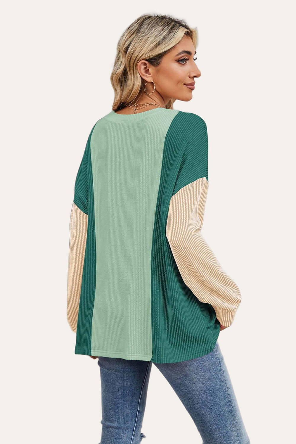 Stylish woman wearing Double Take Texture Contrast Round Neck Long Sleeve T-Shirt in trendy color combo, perfect for layering.