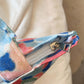 Close-up of a printed canvas handbag with a zipper, showcasing the detailed fabric pattern and sturdy zipper mechanism.