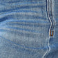 Close-up view of high waist distressed jeans fabric showing details of stitching and texture in Judy Blue Jeans.