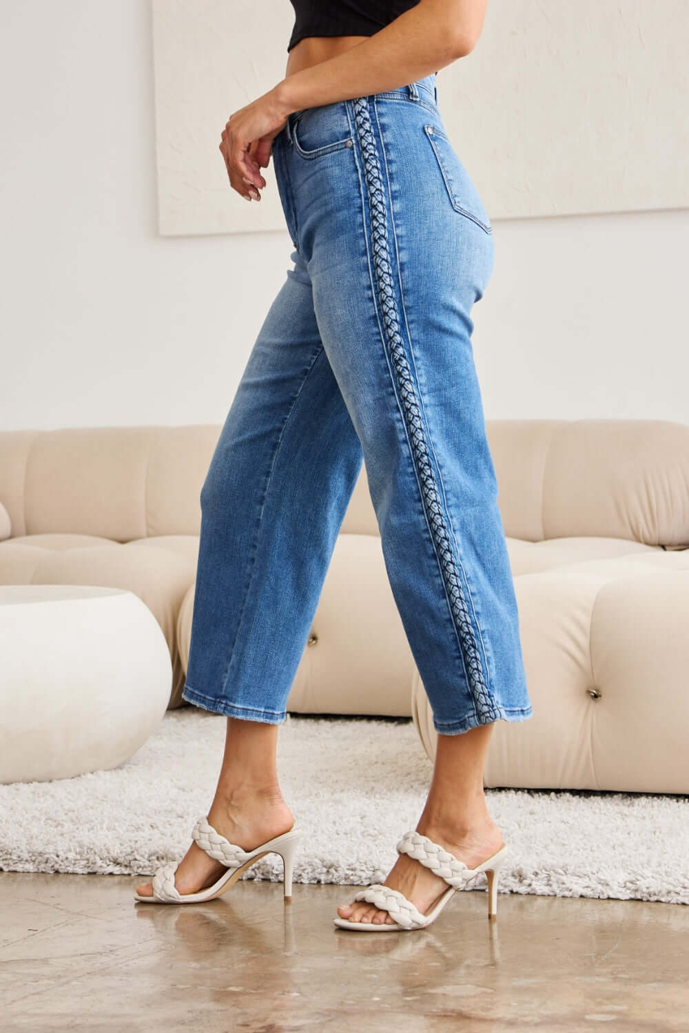 Stylish Judy Blue Jeans with braid side detailing and wide leg silhouette worn by model in chic setting