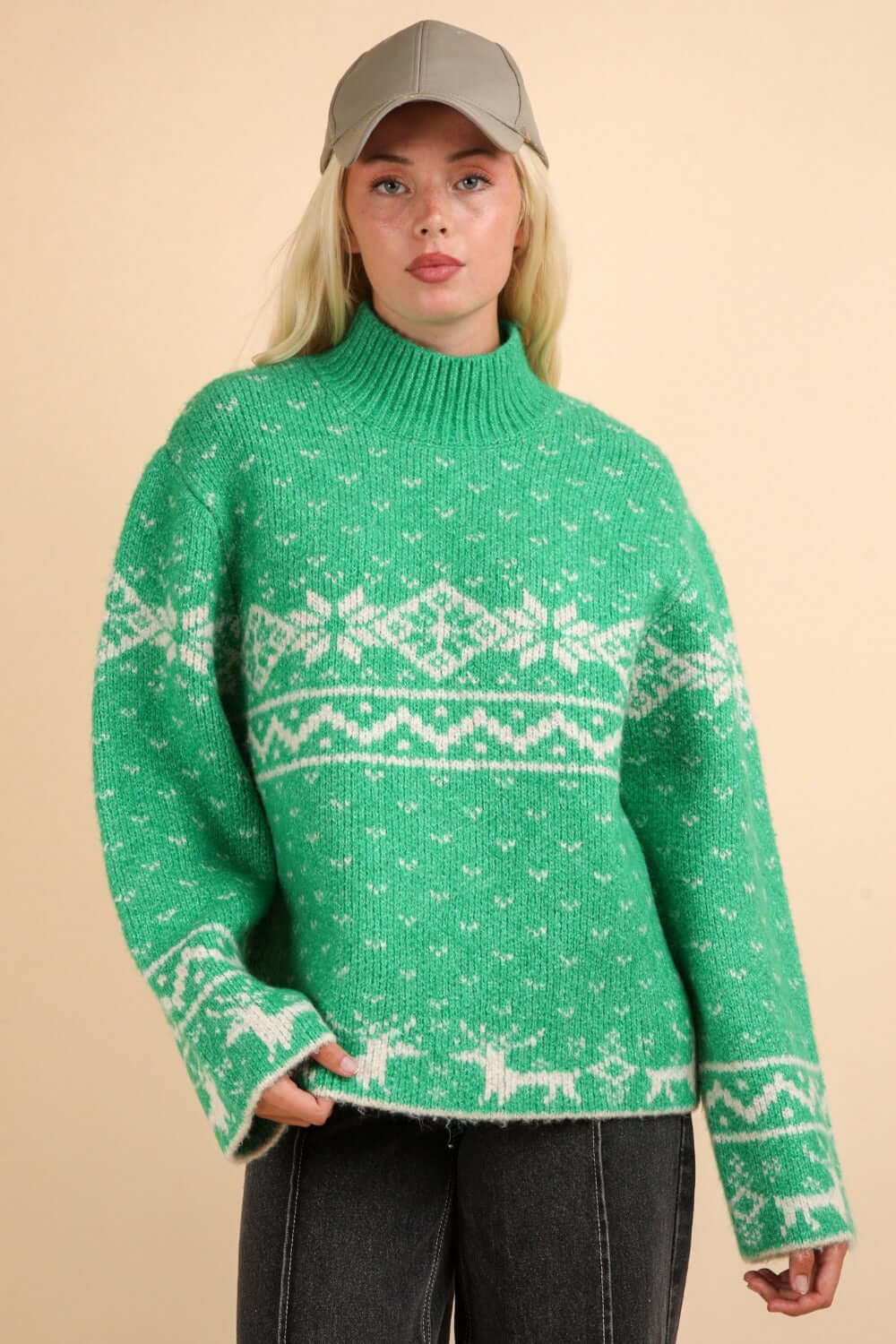 Festive green Christmas sweater with snowflakes and reindeer design, mock neck, and long sleeves for cozy winter warmth.