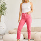 Woman wearing Crop Dylan Full Size Tummy Control High Waist Raw Hem Jeans by RFM Jeans in a stylish casual setting.