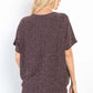 Woman wears full size Lurex knit top with center elastic cinch, showcasing sparkling texture and casual elegance from the back view.