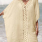 Woman wearing a cutout V-neck three-quarter sleeve sheer cover up at the beach