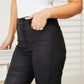 High Rise Black Coated Ankle Skinny Jeans with Exposed Button Closure and Sleek Finish