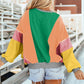 Woman wearing Bella Road Color Block Round Neck Long Sleeve Top and denim shorts from behind, showcasing the vibrant design