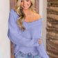 Woman wearing Bella Road frayed hem dropped shoulder sweater in lilac, stylish and playful fashion piece.