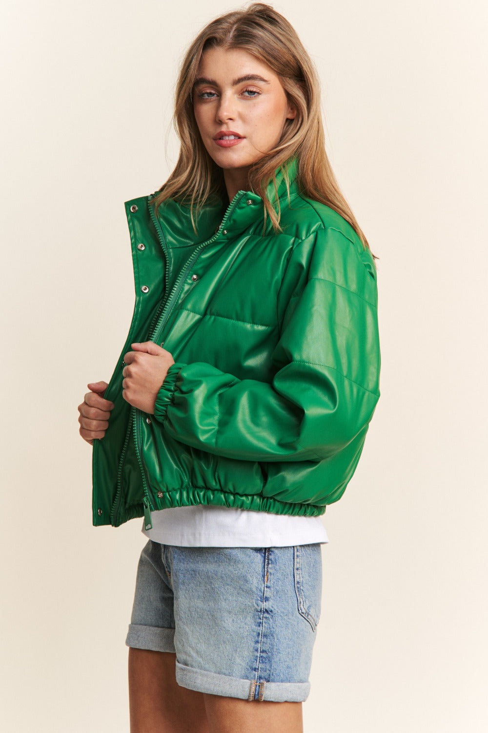 Green faux leather crop puff jacket with turtleneck, zipper and snap closures, perfect for fall and winter style and warmth.