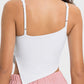 Back view of Millennia Slit Asymmetrical Neck Active Cami in white, showcasing its stylish slit detail and adjustable straps.