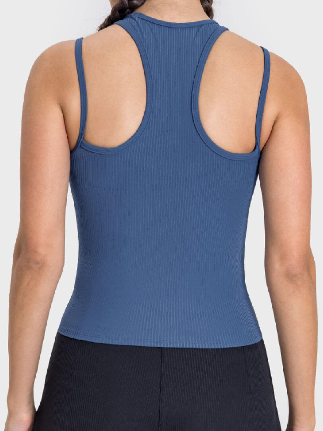 Back view of the Millennia Cutout Racerback Active Tank in blue, showcasing its unique cutout design and comfortable fit.