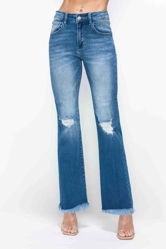 Model showcasing bytos Full Size Raw Hem Distressed High Rise Bootcut Jeans with raw hem and distressed details.