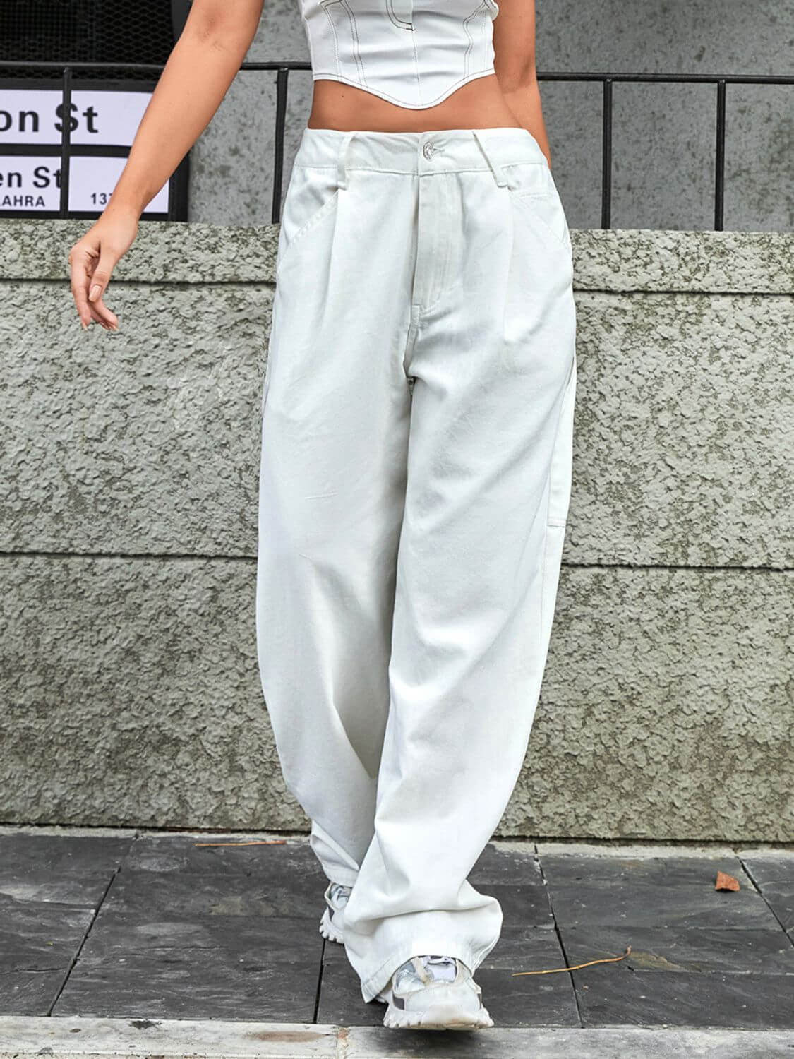 Bella Road wide leg jeans with pockets in white, worn with a crop top, featuring a buttoned and pocketed low waist design.