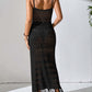 Woman wearing black openwork scoop neck cover-up dress with tassels, semi-sheer and slightly stretchy material, back view.