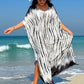 Woman wearing a Slit Tie-Dye Half Sleeve Cover Up on a beach, with a wide-brimmed hat and sunglasses.