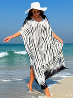 Woman wearing a Slit Tie-Dye Half Sleeve Cover Up on a beach, with a wide-brimmed hat and sunglasses.