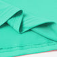 Close-up of turquoise round neck short sleeve T-shirt fabric, showcasing its slightly stretchy 100% polyester material and neat stitching.