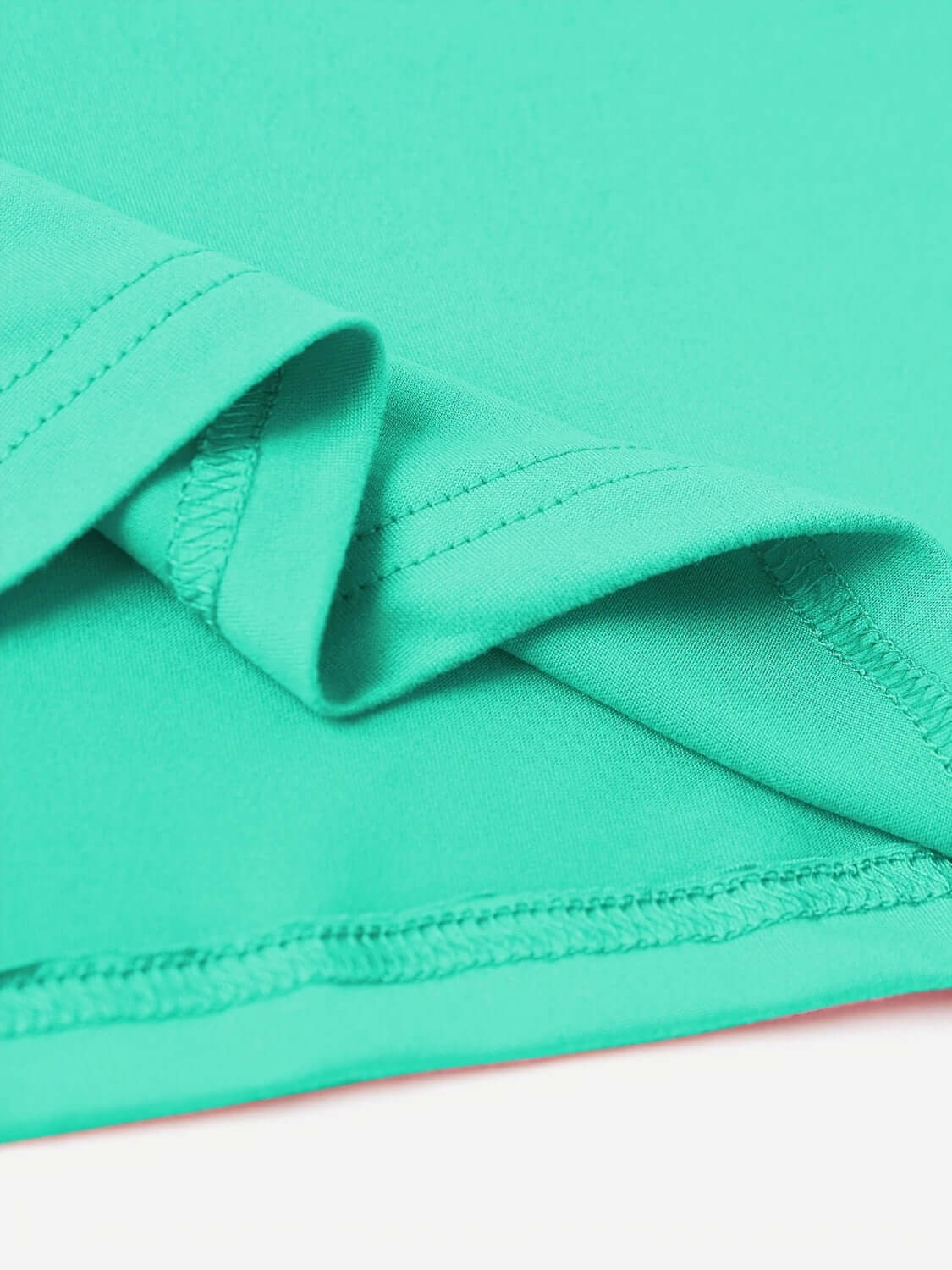 Close-up of turquoise round neck short sleeve T-shirt fabric, showcasing its slightly stretchy 100% polyester material and neat stitching.