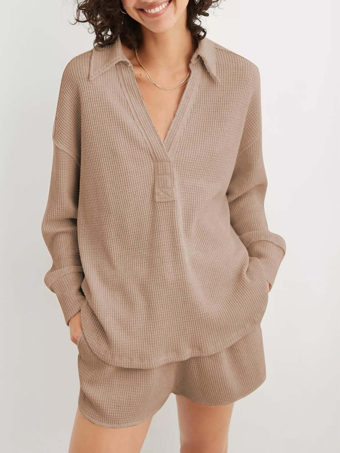 Woman wearing a Waffle-Knit Johnny Collar Long Sleeve Sweatshirt in beige with matching shorts, featuring slightly stretchy fabric