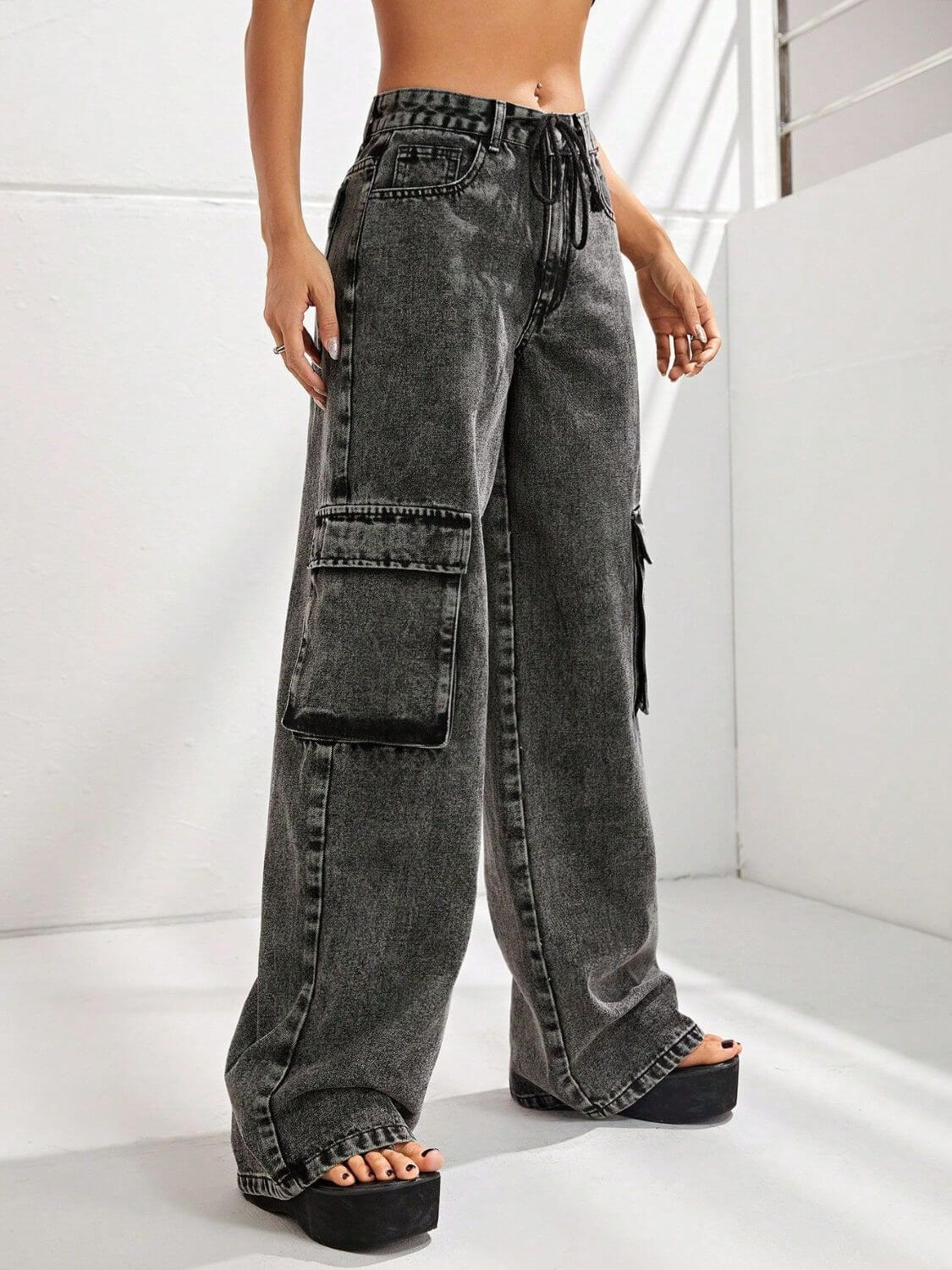 Bella Road wide leg jeans with pockets, black denim, high waist, relaxed fit, modeled with drawstring waist and cargo-style pockets.