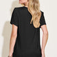 Woman wearing black Bamboo V-Neck High-Low T-Shirt, back view showing casual fit and short sleeves.