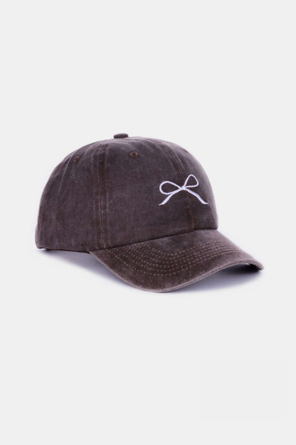 Bow Embroidered Washed Cotton Cap in dark color with delicate bow design, offering a stylish and comfortable fit for all-day wear.