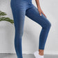 High waist skinny jeans with moderate stretch showing a flattering fit and pocket detail, worn with white sneakers.