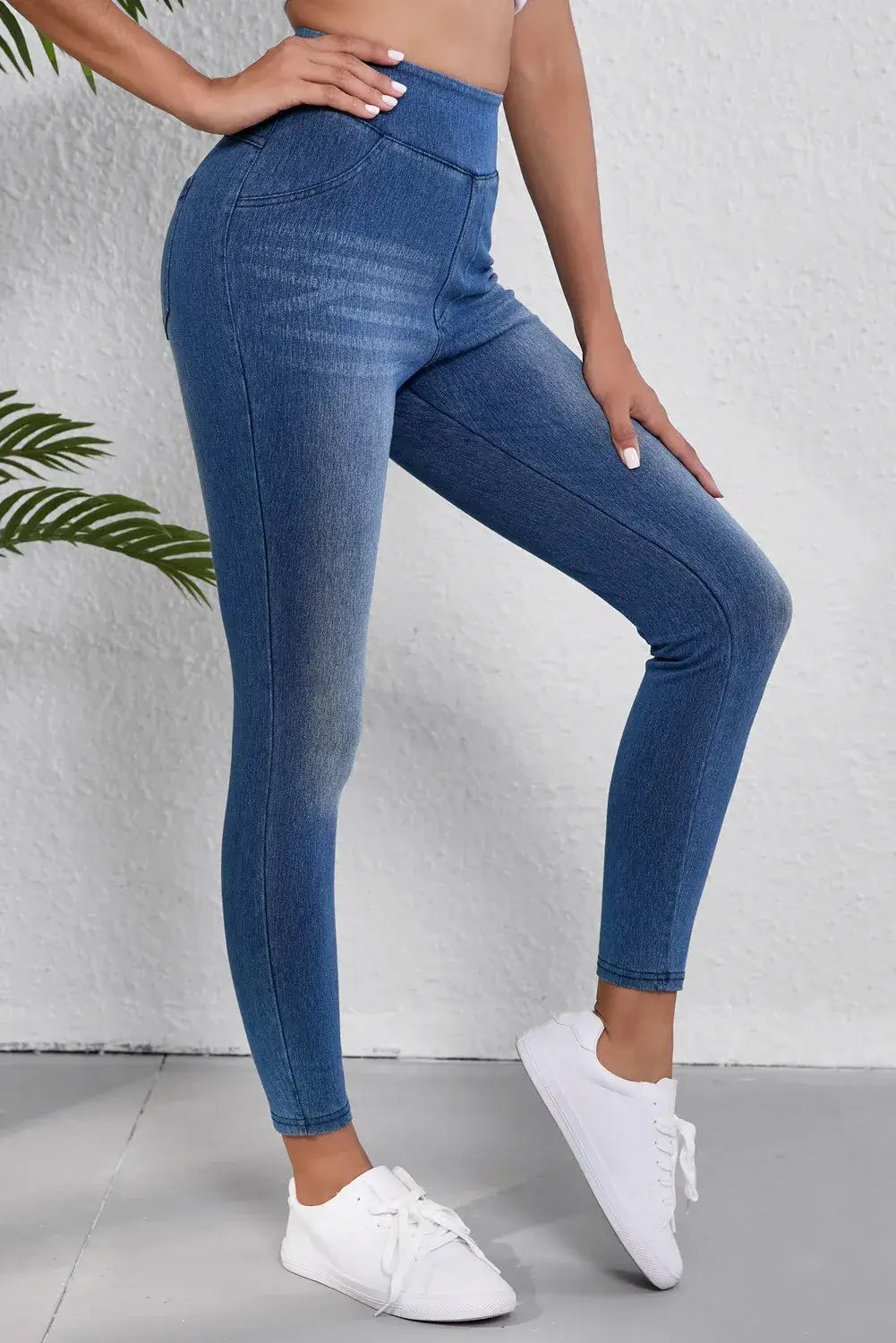 High waist skinny jeans with moderate stretch showing a flattering fit and pocket detail, worn with white sneakers.