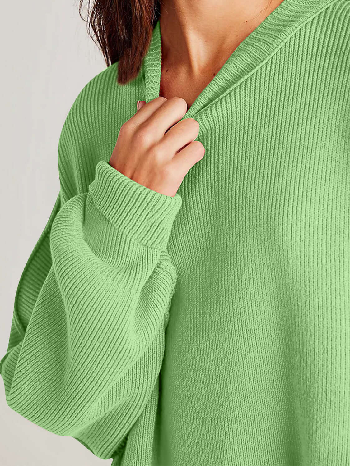 Double Take Side Slit Round Neck Long Sleeve Sweater in green material close-up showing cozy stretch fabric and playful design.