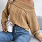 Woman wearing Bella Road Cable-Knit One Shoulder Long Sleeve Sweater styled with jeans and handbag