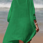 Woman wearing a green Cutout V-Neck Three-Quarter Sleeve Cover Up on a beach