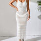 Woman wearing white openwork scoop neck cover-up dress with tassel details and semi-sheer texture standing against light background.