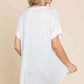 Woman wearing a versatile white round neck short sleeve t-shirt, showing the back view of the relaxed fit design.