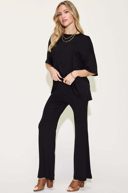 Woman wearing a black Bamboo Drop Shoulder T-Shirt and Flare Pants Set, featuring a basic style, made of 95% bamboo fiber and 5% spandex.