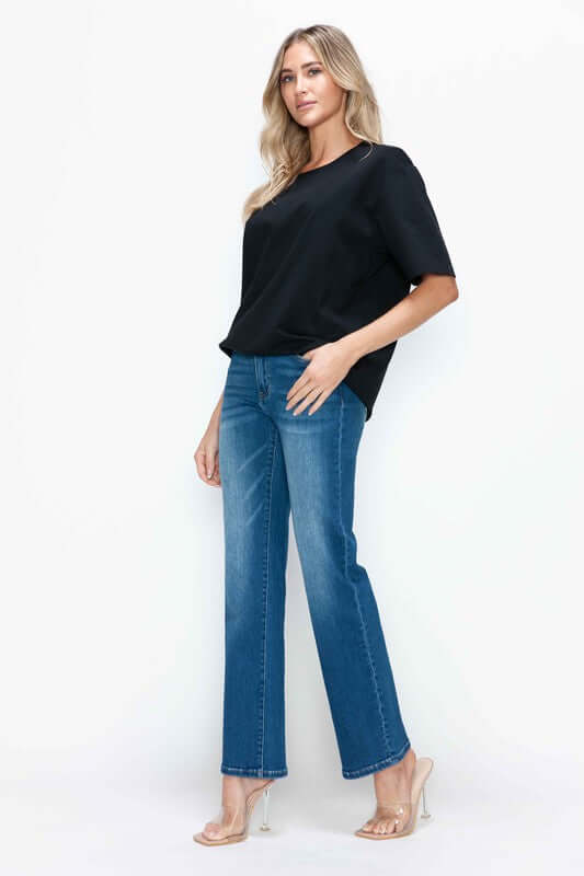 Model showcasing bytos Cat's Whiskers High Rise Straight Jeans paired with a stylish black top, highlighting modern vintage fashion.